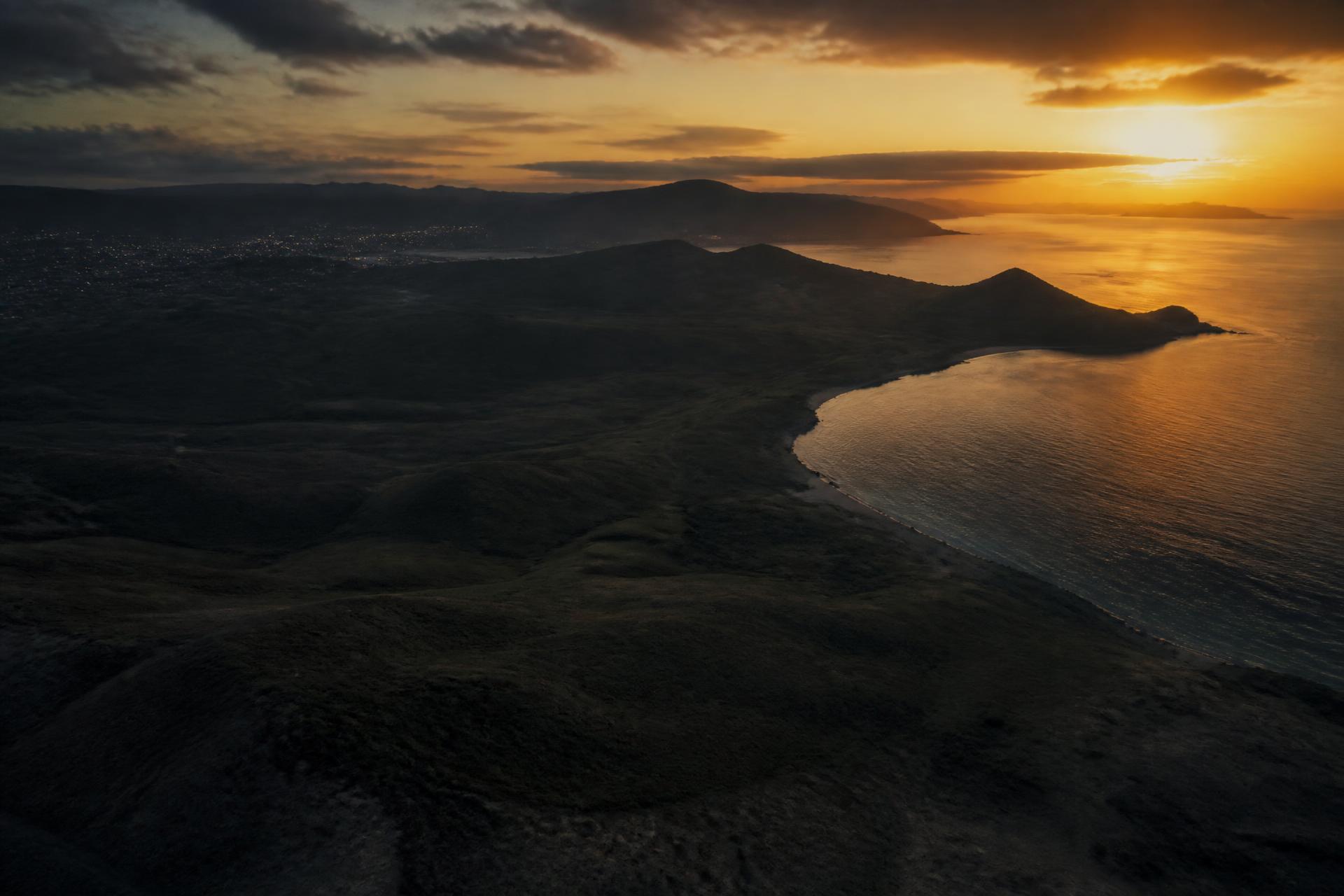 Aerial view of undeveloped coastal land at golden dusk
